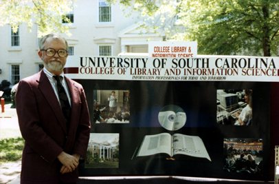Dean Roper, shown with special College traveling exhibit show on the grounds of the Horseshoe at annual Spring Alumni Day